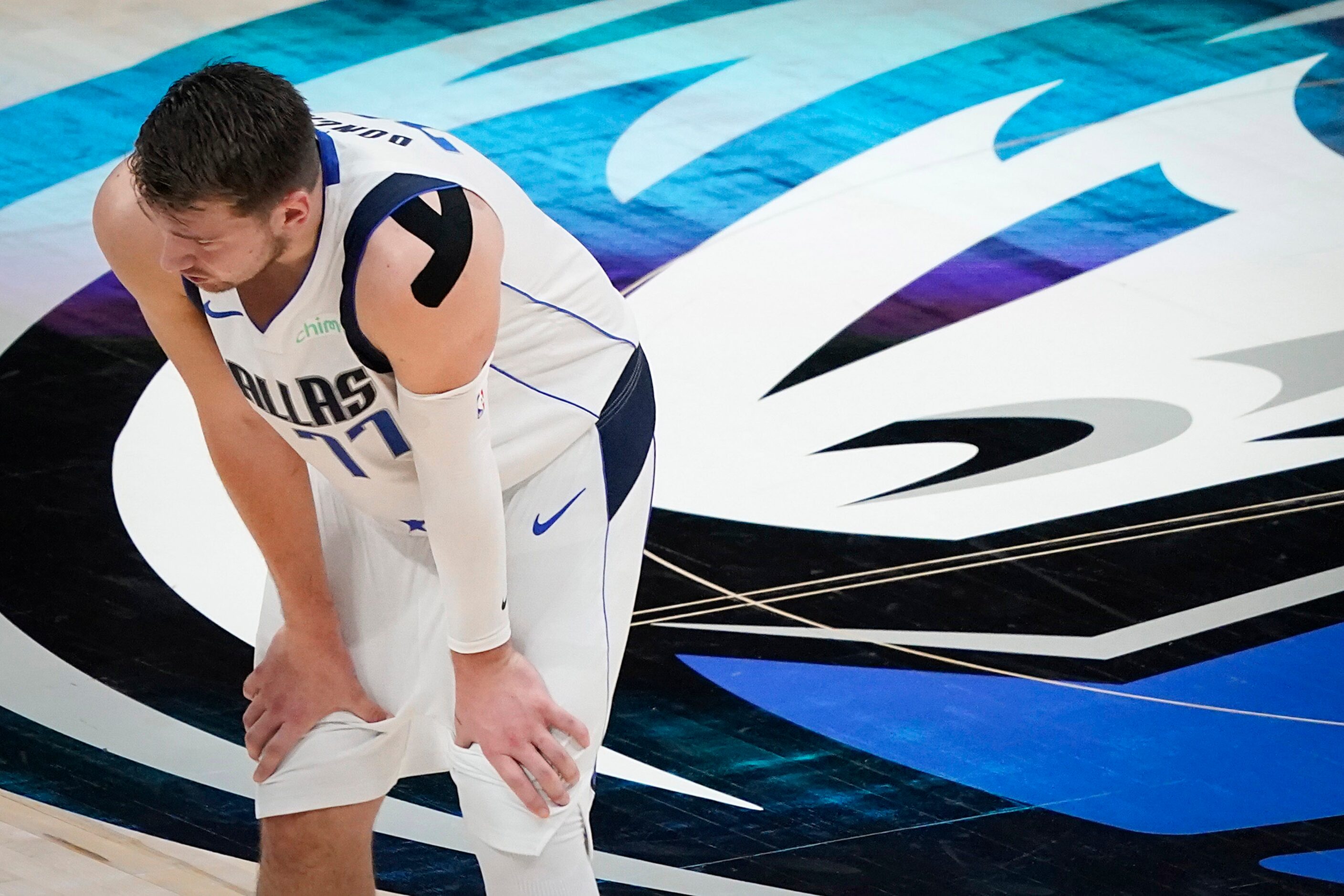 Dallas Mavericks guard Luka Doncic (77) catches his breath during a stop in play during the...