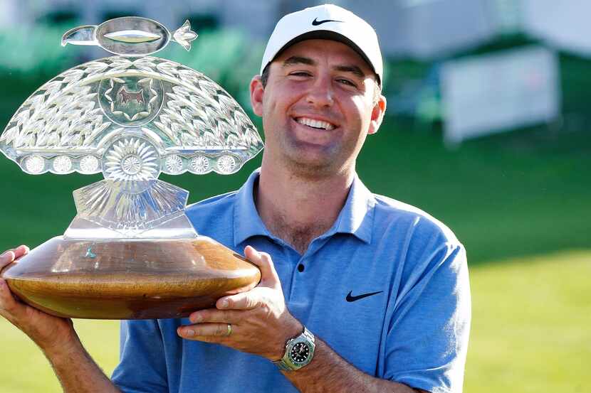 Scottie Scheffler holds up the championship trophy after the final round of the Phoenix Open...