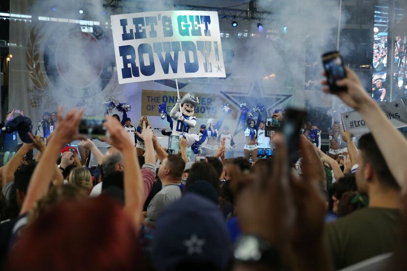 Dallas Cowboys mascot Rowdy interacts with fans as they react during a watch party moments...