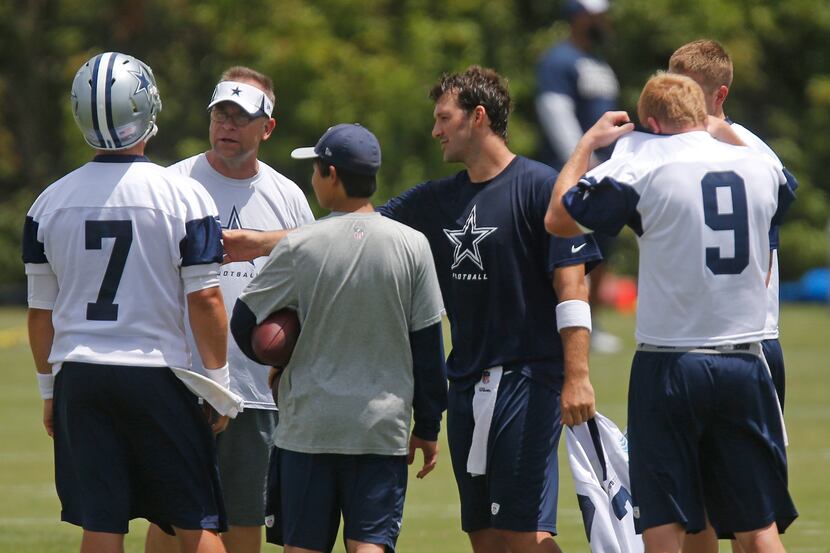 Dallas quarterback Tony Romo, blue shirt, trades jerseys with quarterback Caleb Hanie (7),...