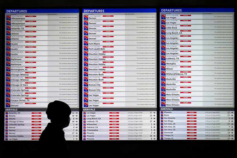Flight status boards show flights canceled for Southwest Airlines at Dallas Love Field after...