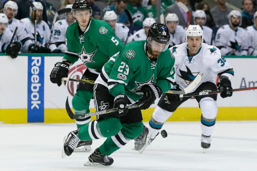 Dallas Stars defenseman Greg Pateryn (29) chases the puck in front of teammate Jamie...