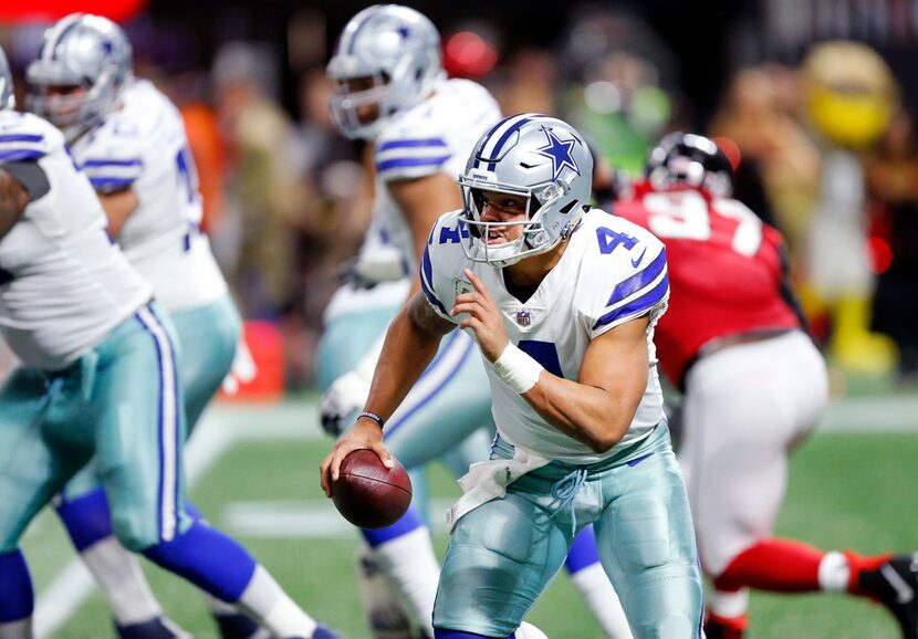 Dallas Cowboys quarterback Dak Prescott (4) rushes with the ball in the second quarter...