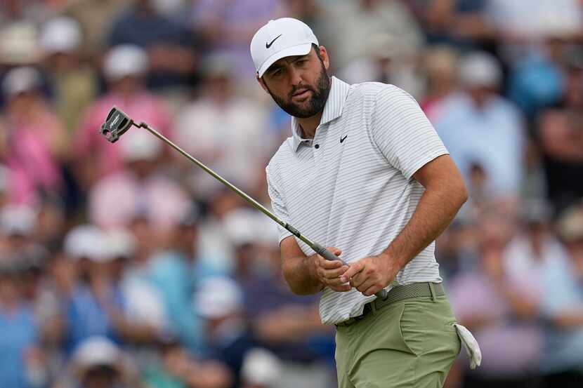 Scottie Scheffler reacts after missing a putt on the seventh hole during the first round of...