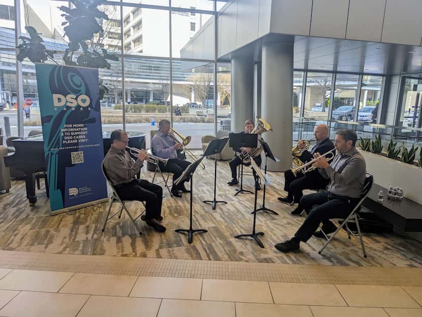 Symphony musicians performing in the lobby of a hospital