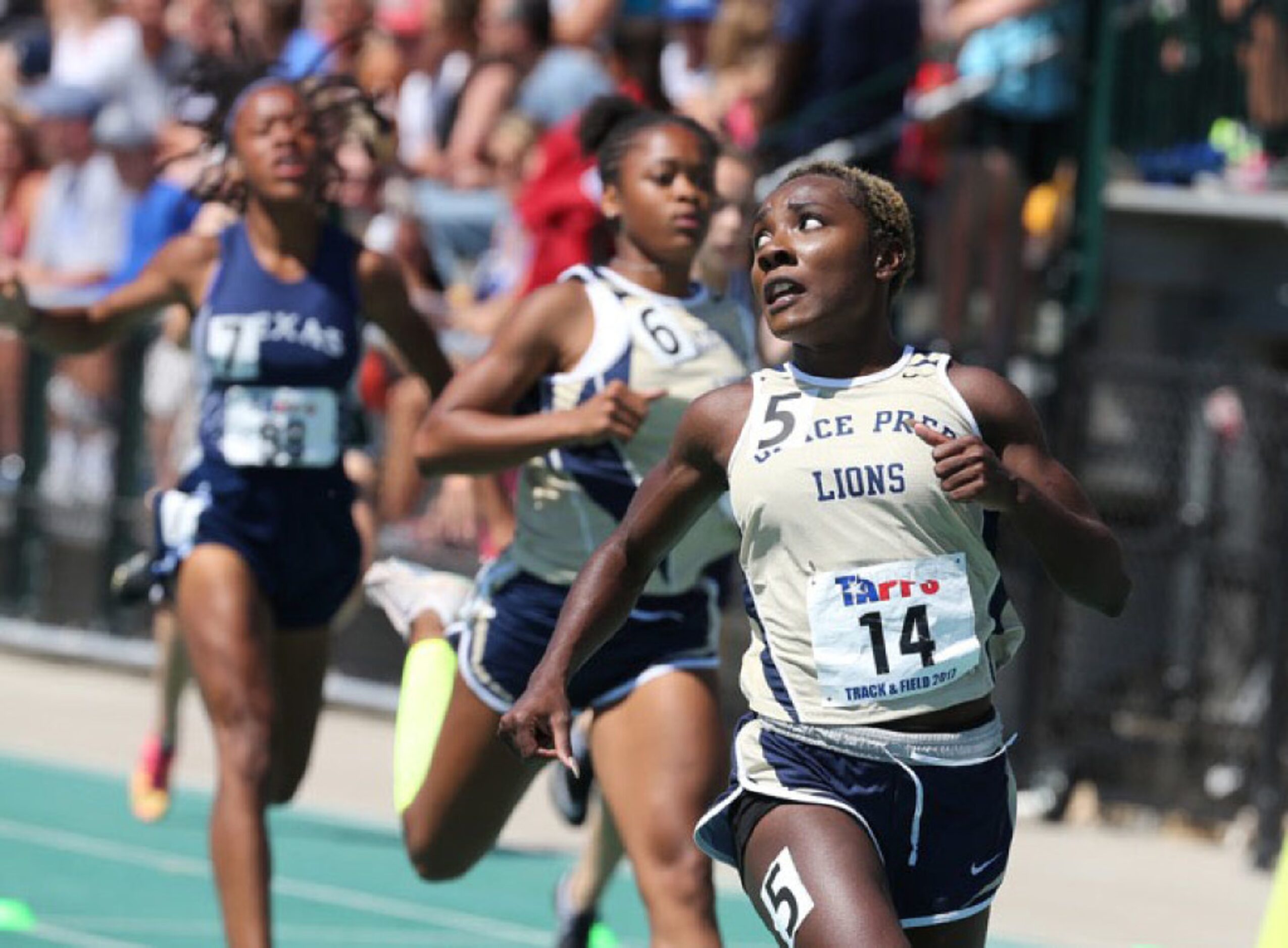 Grace Prep Aliyah Trotter looks back after wining the 4A women 100 meter dash at the TAPPS...