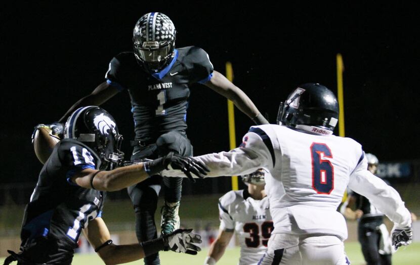 Plano West running back Soso Jamabo (2) jumps and scores a rushing touchdown in the third...