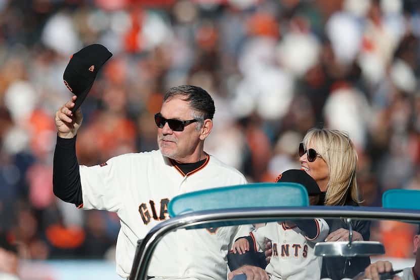 Retiring manager Bruce Bochy of the San Francisco Giants does a lap of honor with his wife,...