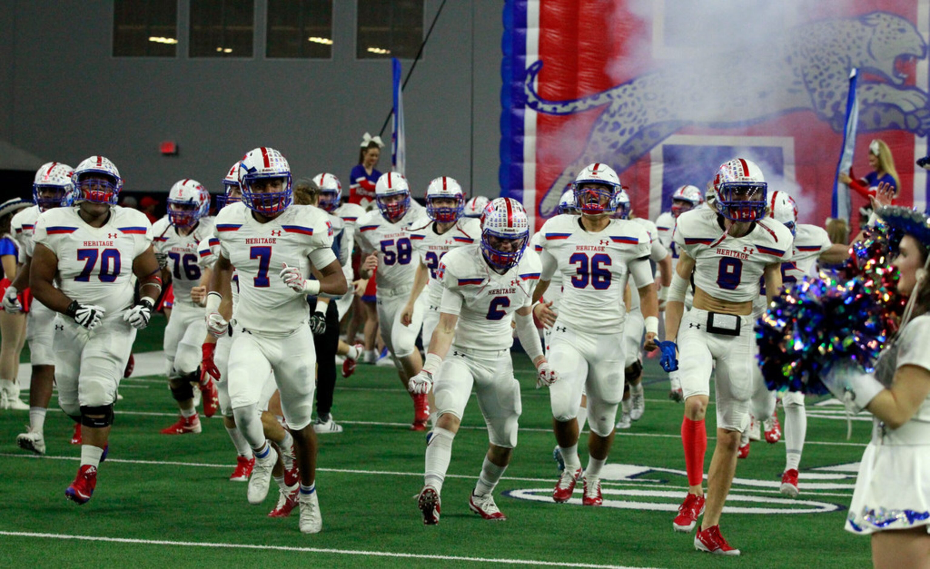 The Midlothian Heritage Jaguars take the field before the start of Class 4A Division I...