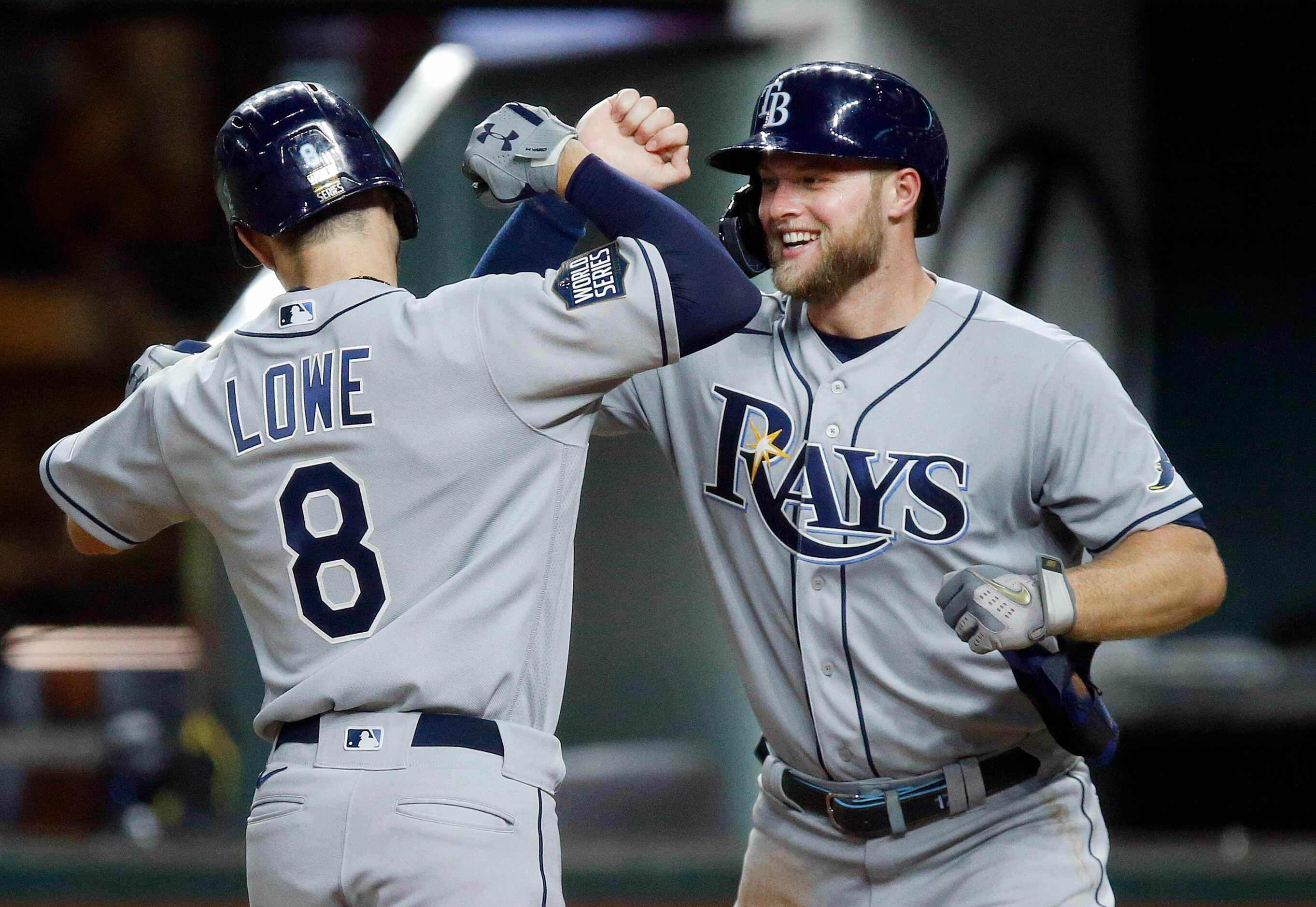Tampa Bay Rays Brandon Lowe (8) is congratulated by teammate Austin Meadows after scoring...