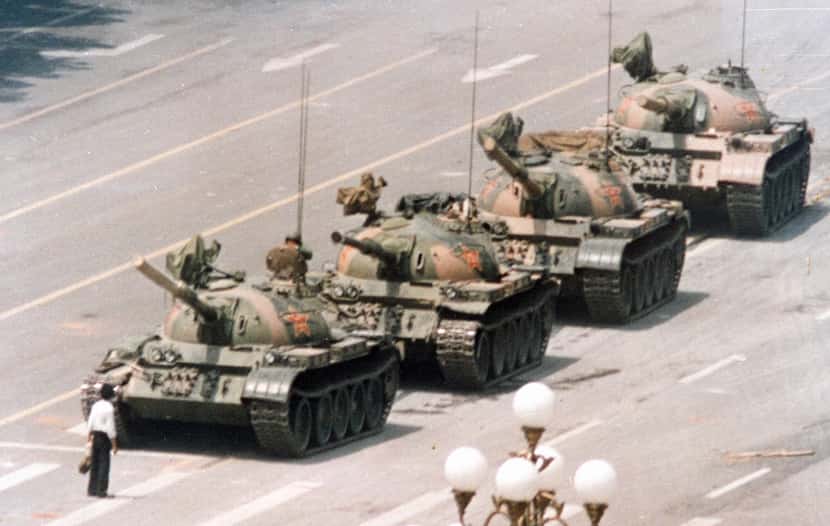 A Chinese man stands in front of a line of tanks in Beijing stopping their advance down...