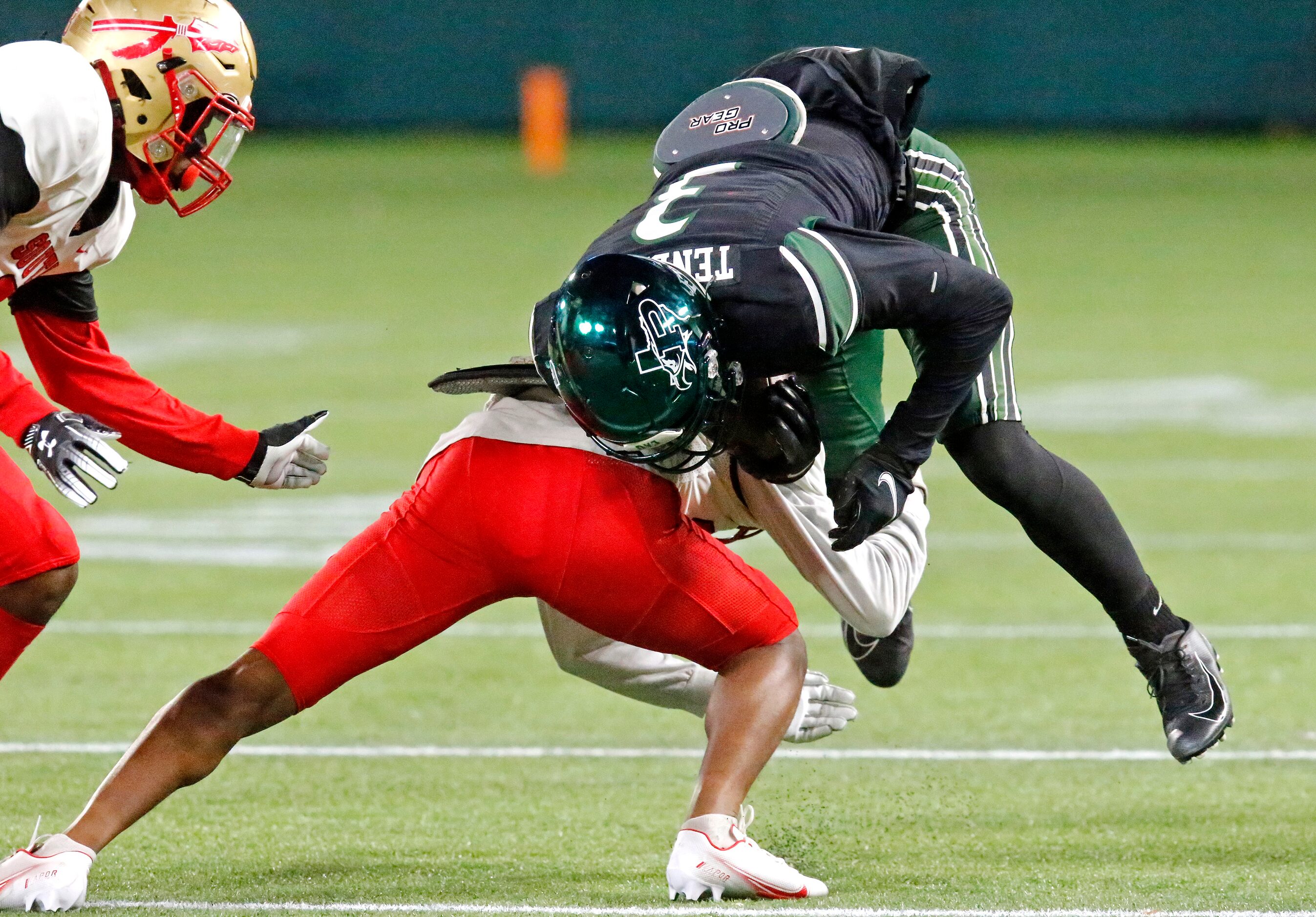 Prosper High School quarterback Nathan TenBarge (3) is upended by South Grand Prairie High...