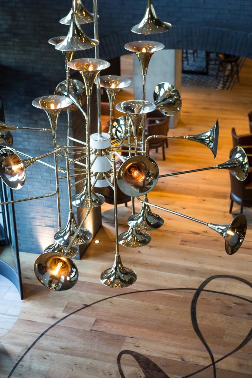 Horn-inspired  chandeliers hang from the ceiling in the hotel’s lobby.