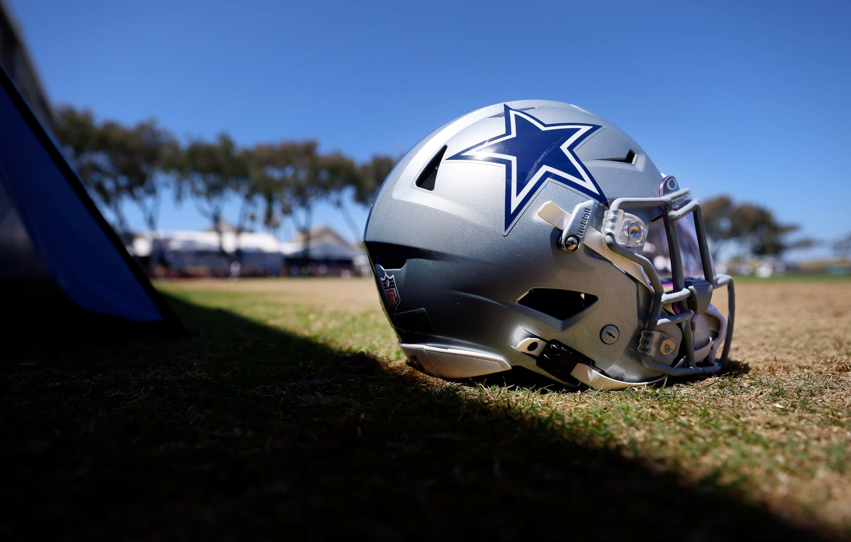 A Dallas Cowboys defensive players helmet is pictured on the sideline during a mock game...