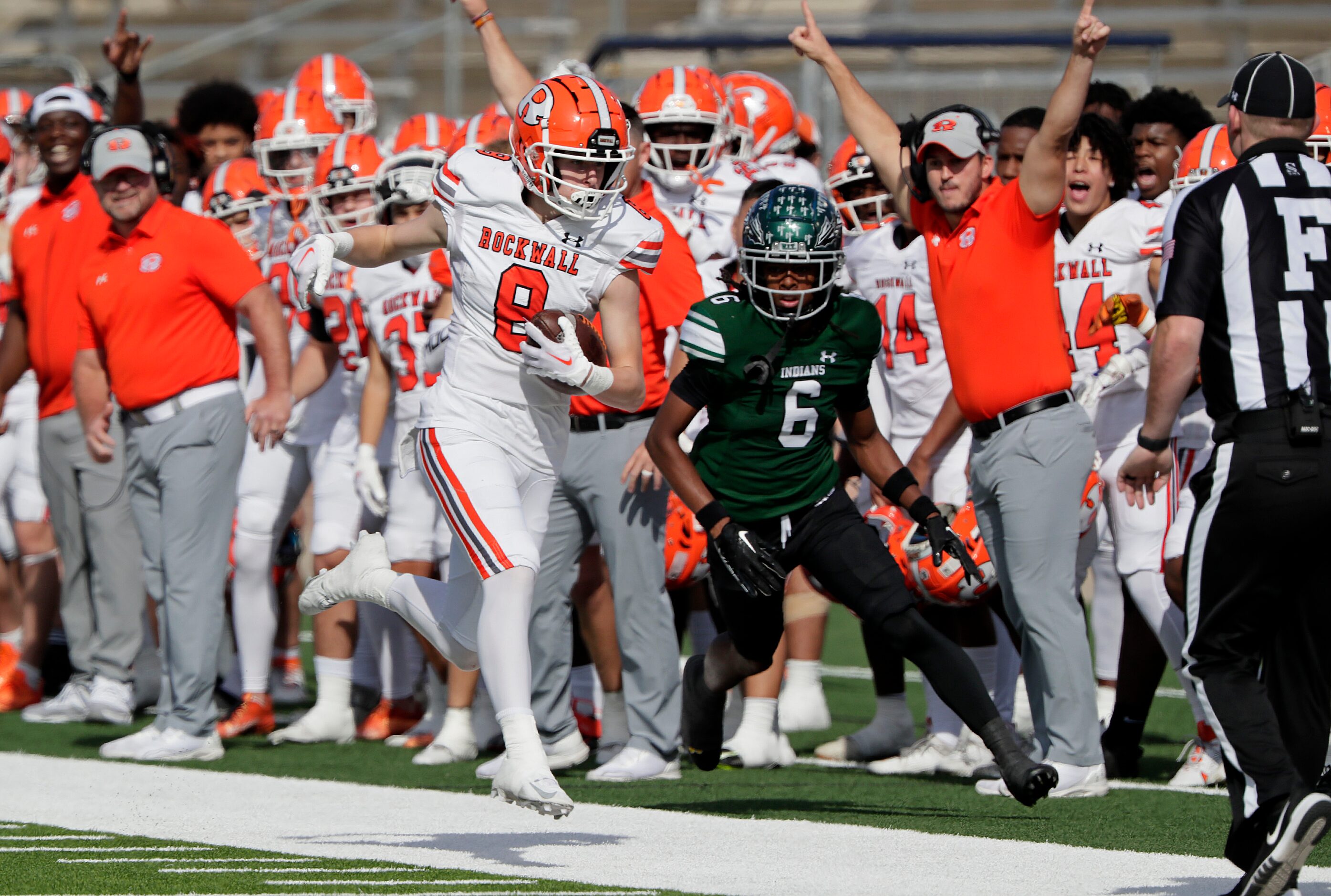 Rockwall High School wide receiver Tristan Gooch (8) catches a pass behind Waxahachie High...