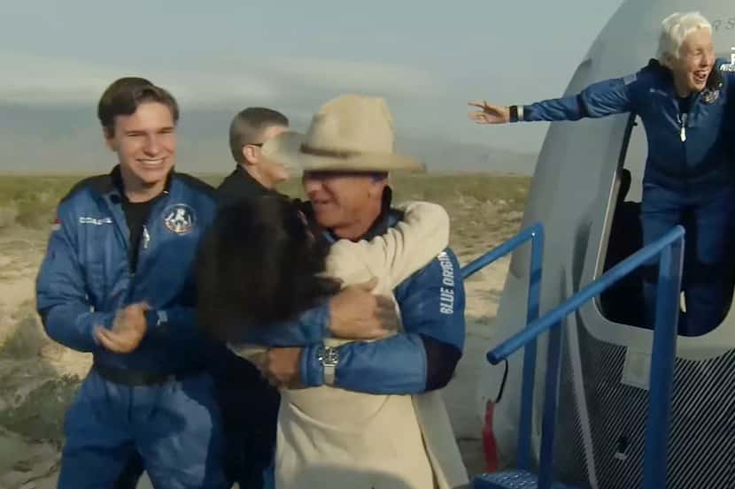 This still image taken from video by Blue Origin shows Jeff Bezos(C), Wally Funk(R) and...