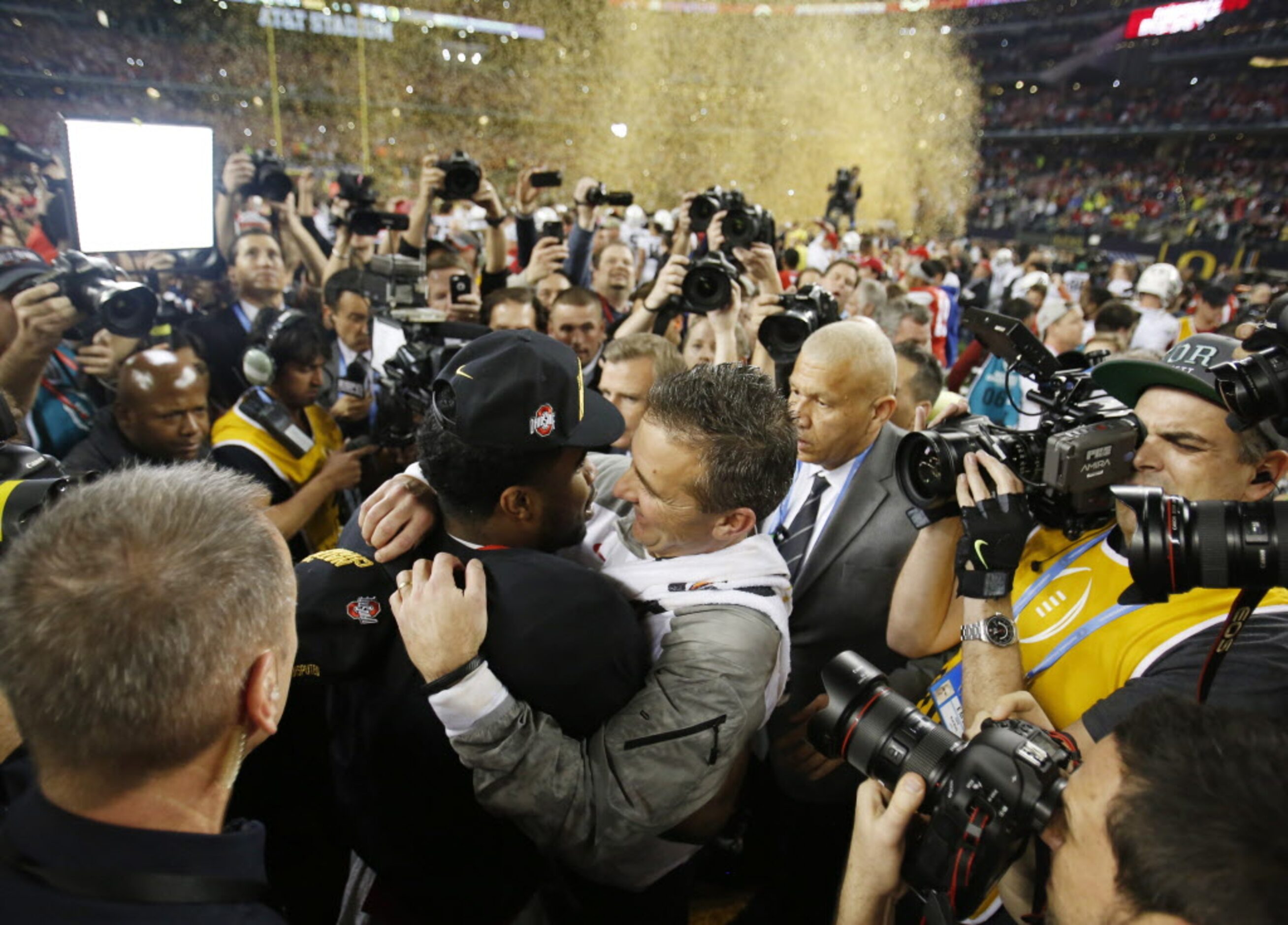 Ohio State Buckeyes running back Ezekiel Elliott (15) hugs  head coach Urban Meyer after...