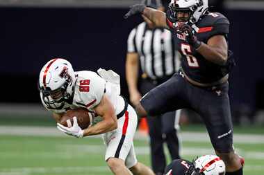 Texas Tech's Dalton Rigdon (86) tries to break away from Douglas Coleman III (3) during an...