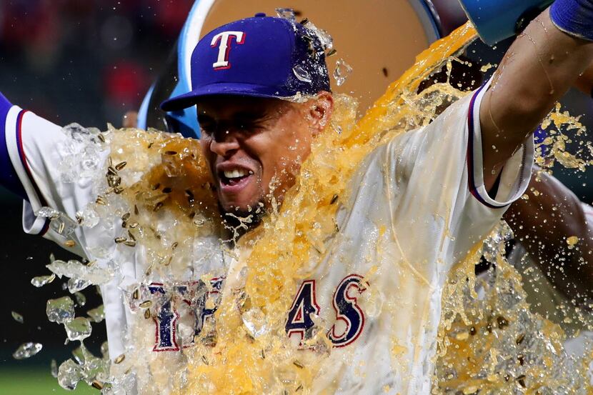 ARLINGTON, TX - SEPTEMBER 28:  Carlos Gomez #14 of the Texas Rangers is soaked with Powerade...