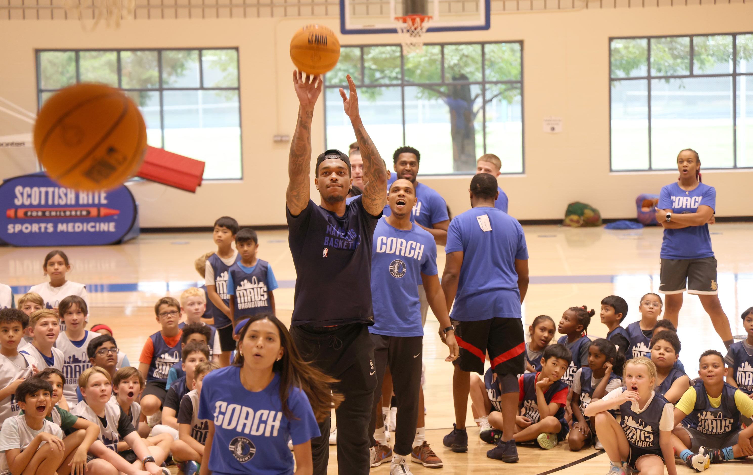 Dallas Mavericks power forward and center PJ Washington puts up a shot to the delight of...