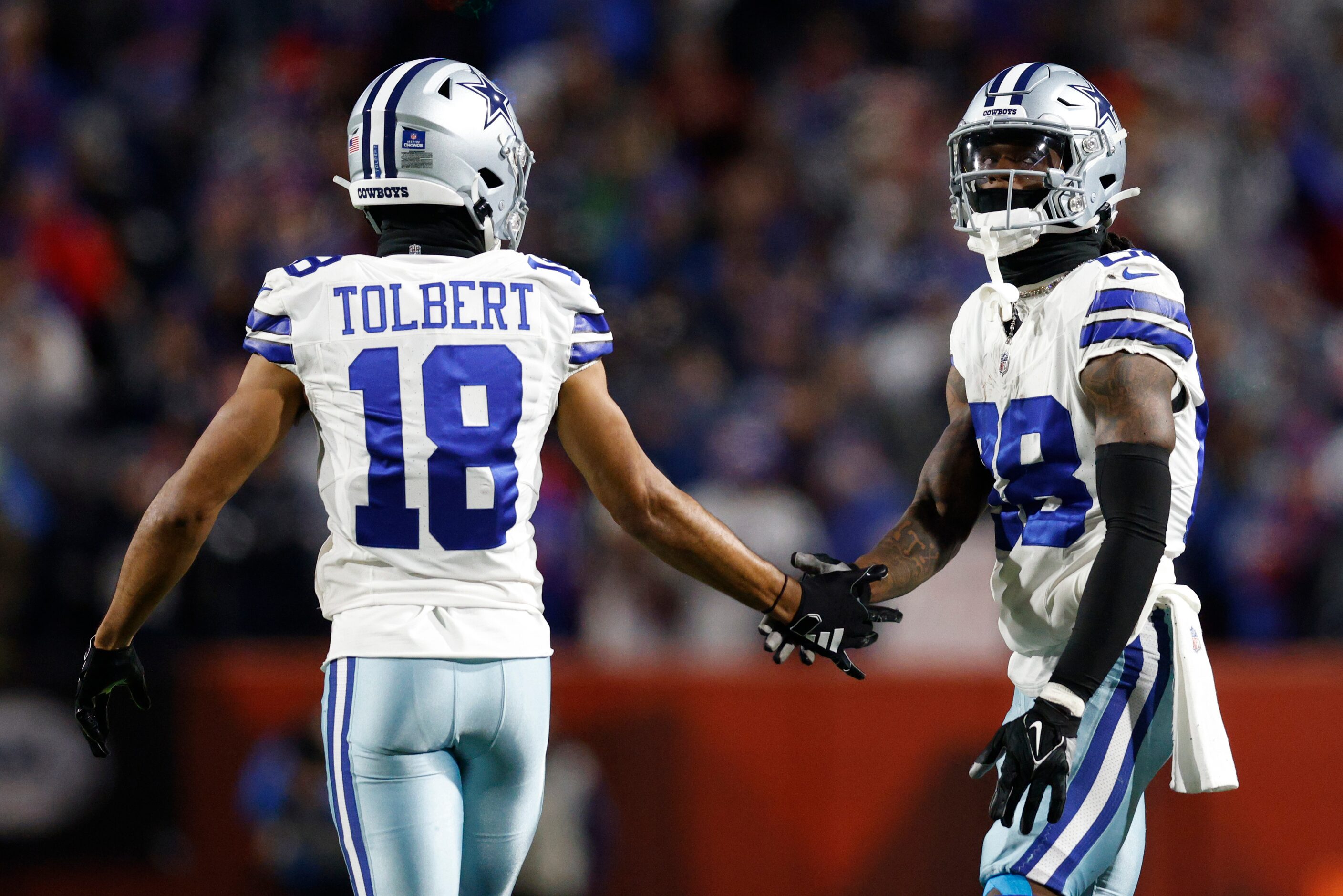 Dallas Cowboys wide receiver Jalen Tolbert (18) high-fives wide receiver CeeDee Lamb (88)...