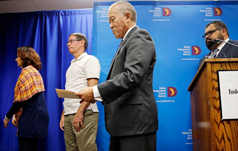 
Mike Miles (center) announced his resignation as superintendent Tuesday. Trustees voted...