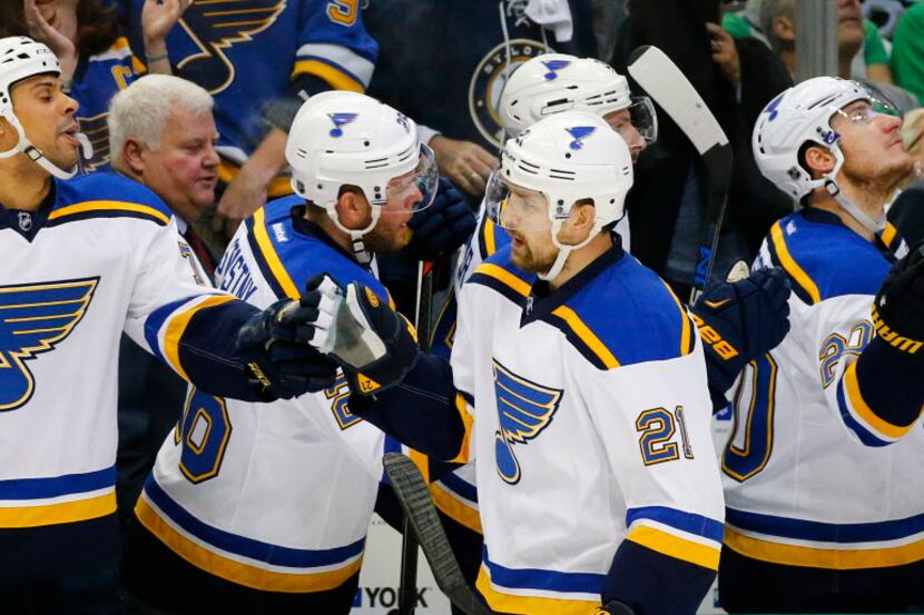 St. Louis Blues center Patrik Berglund (21) is congratulated by teammates after scoring a...
