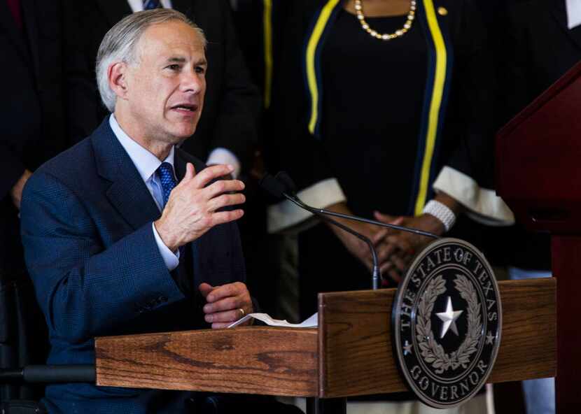 Texas Gov. Greg Abbott speaks during a press conference on Friday at Dallas City Hall.
