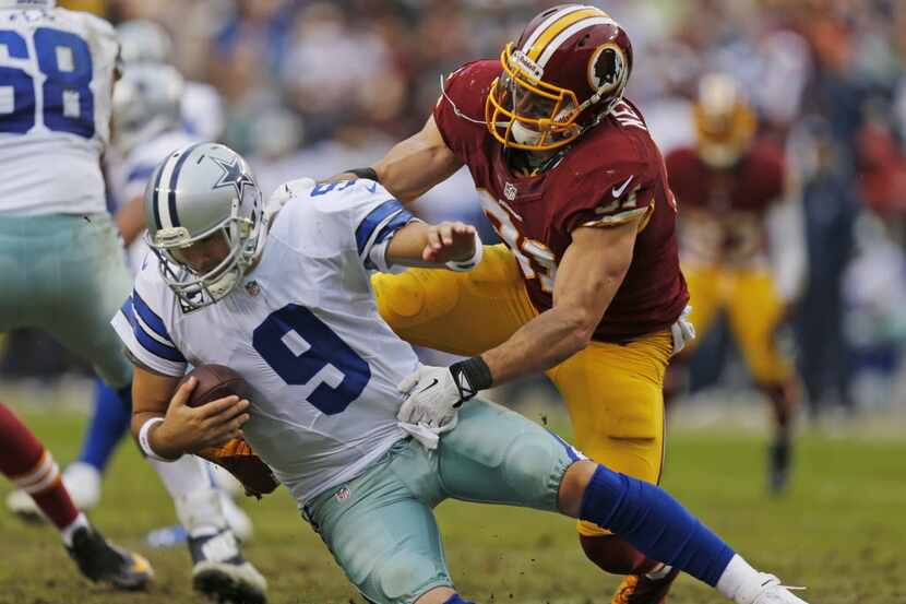 Dallas Cowboys quarterback Tony Romo (9) is sacked by Washington Redskins outside linebacker...