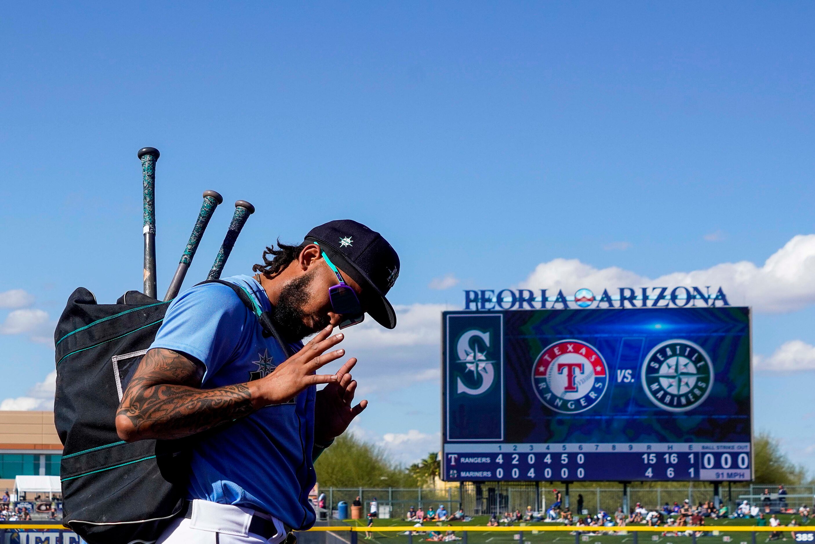 Seattle Mariners shortstop J.P. Crawford acknowledges cheers from fans as he leaves the...