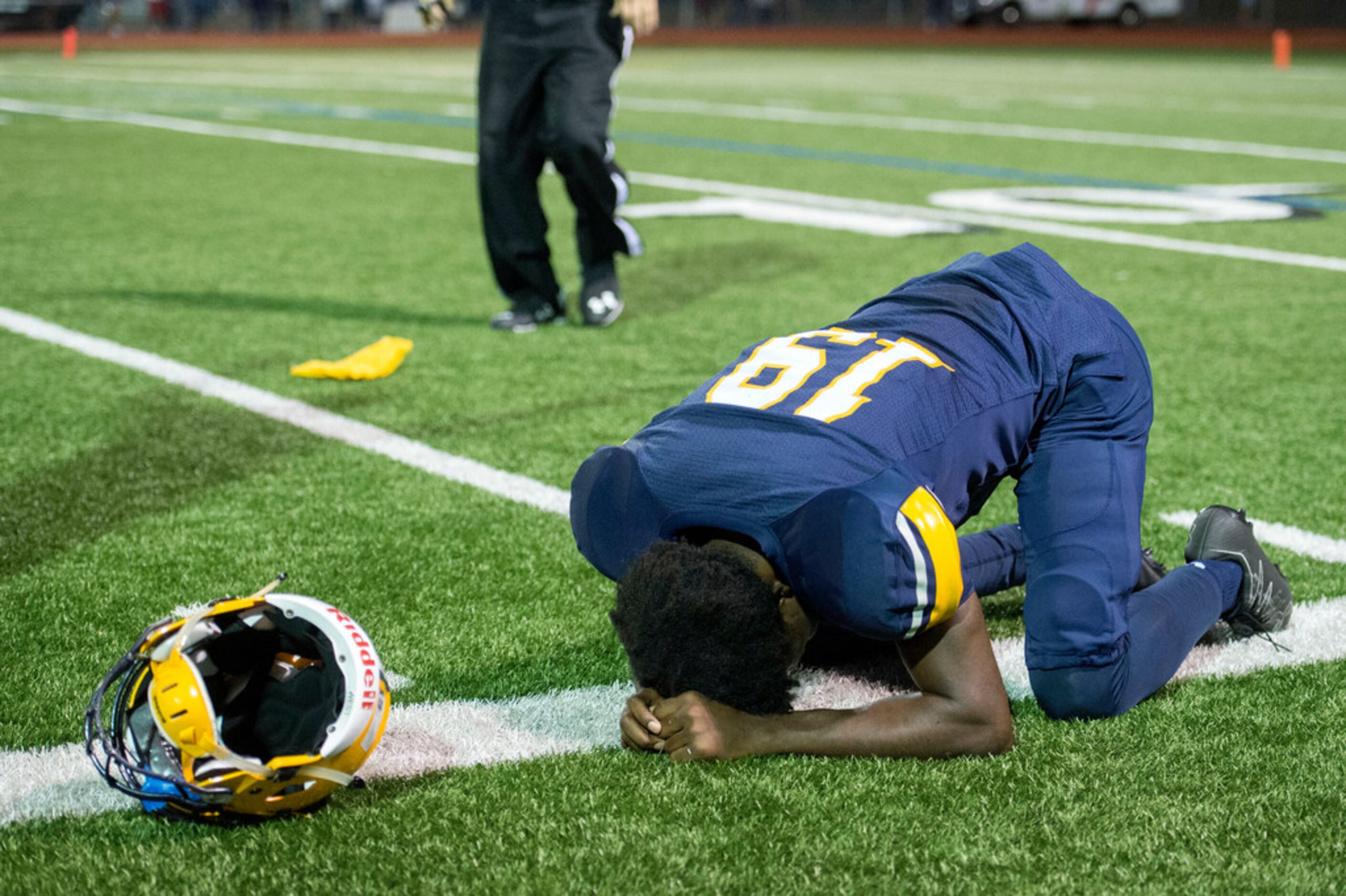 Arlington Lamar sophomore wide receiver Trevon West (19) holds his head in his hands after...