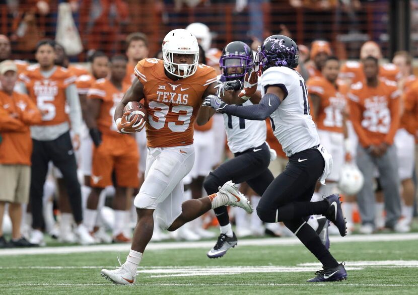 Texas running back D'Onta Foreman (33) is pursued by TCU safety Nick Orr (18) on a 44-yard...