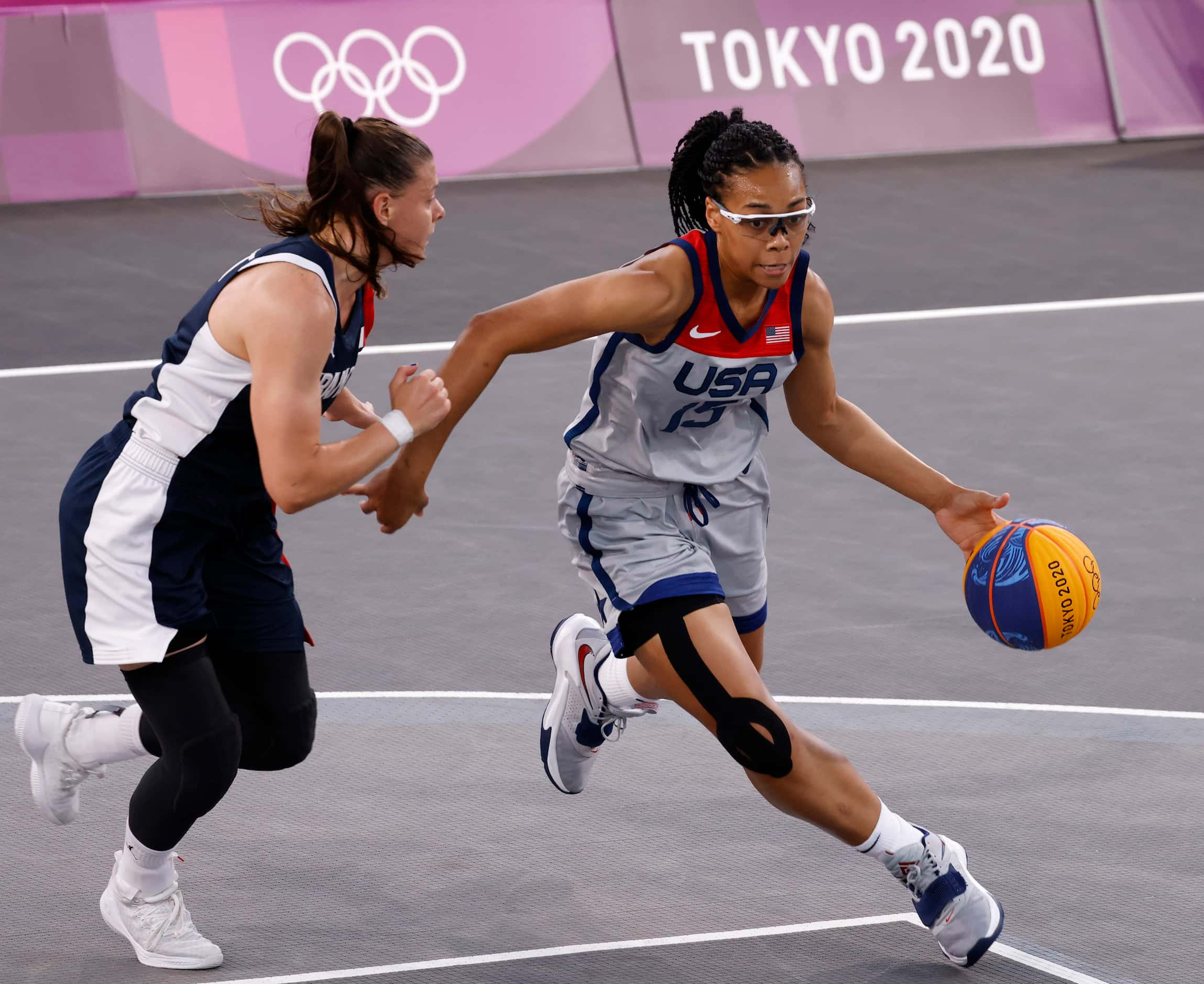 USA’s Allisha Gray (15) drives towards the basket as France’s Marie-Eve Paget (5) defends...