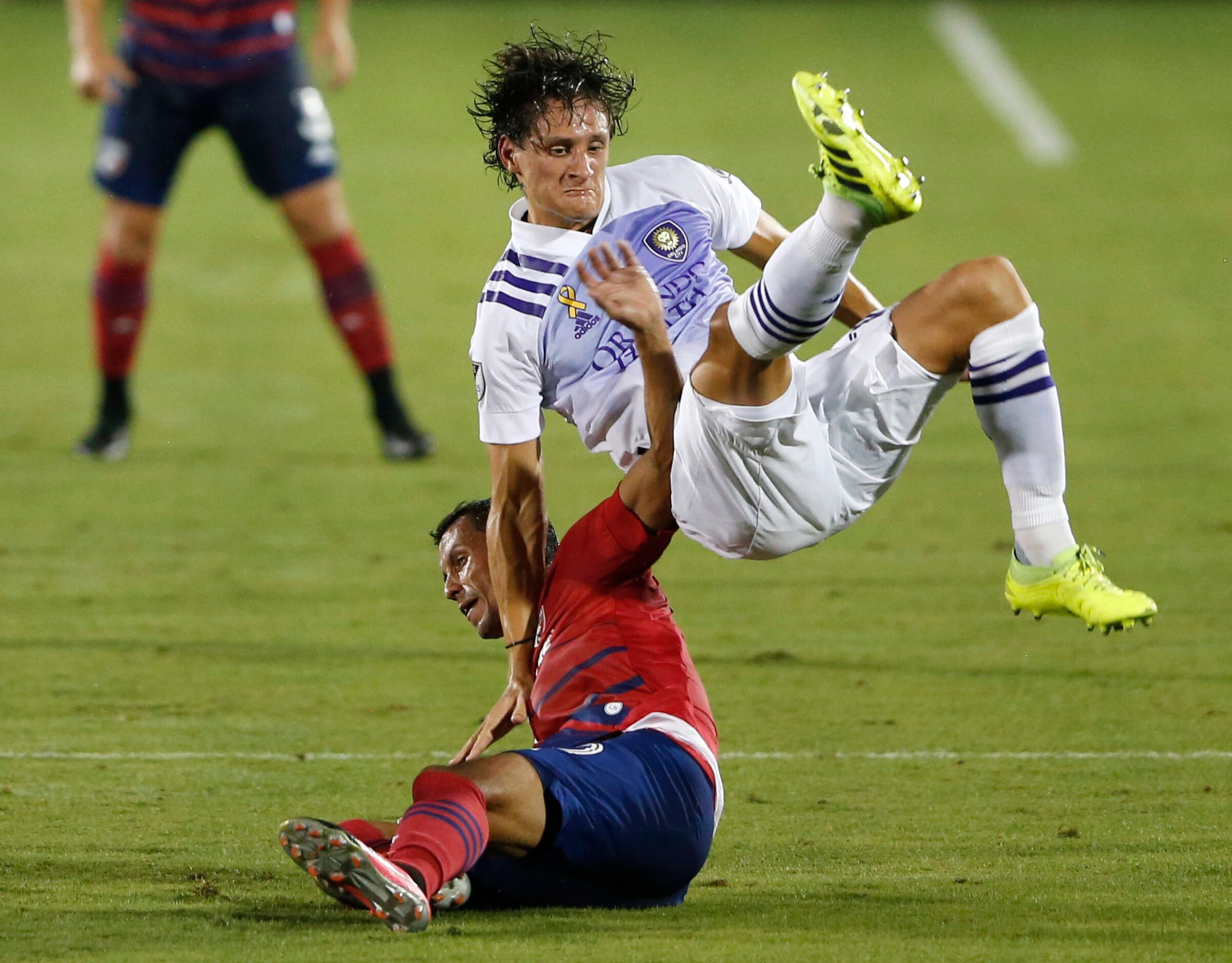 Orlando City defender Rodrigo Schlegel (15) and FC Dallas Pablo Aránguiz (10) collide during...