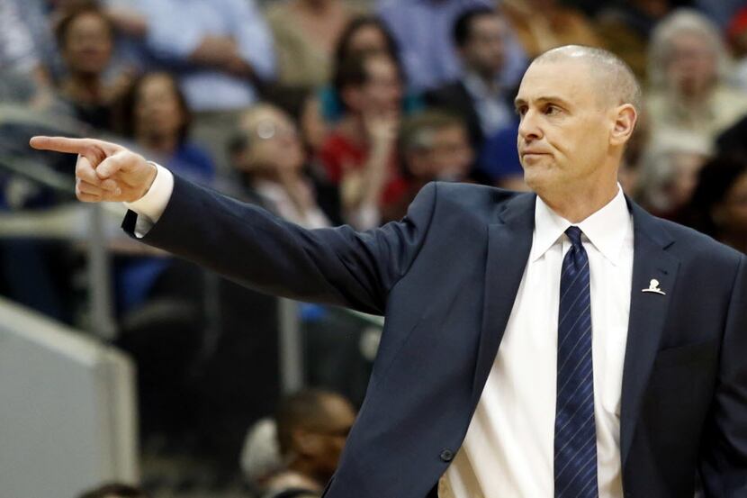 Dallas Mavericks head coach Rick Carlisle points back at the bench in a game against the...