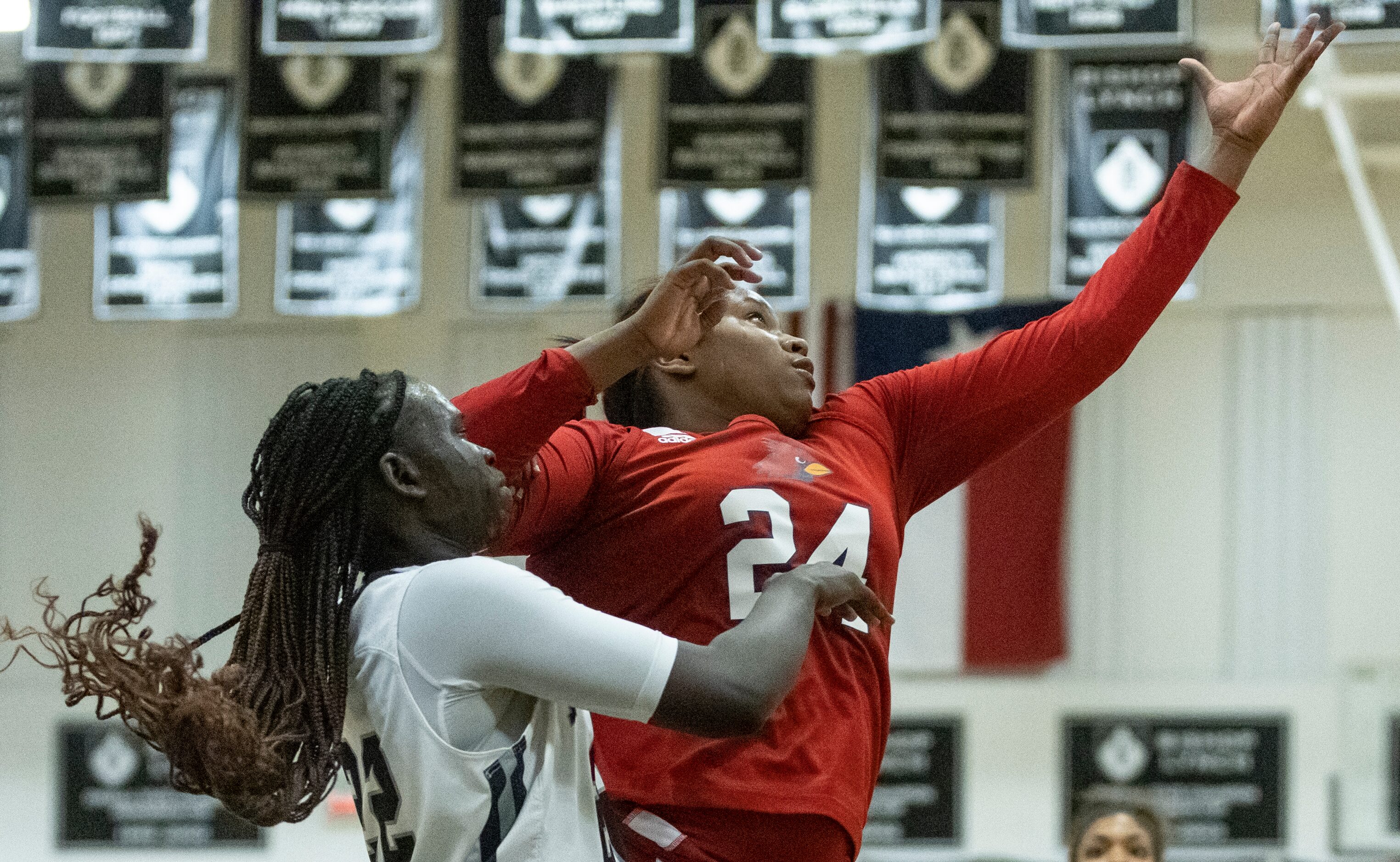 Standing near the basket, John Paul II High School Taylor Haggan (24) reaches to catch a...