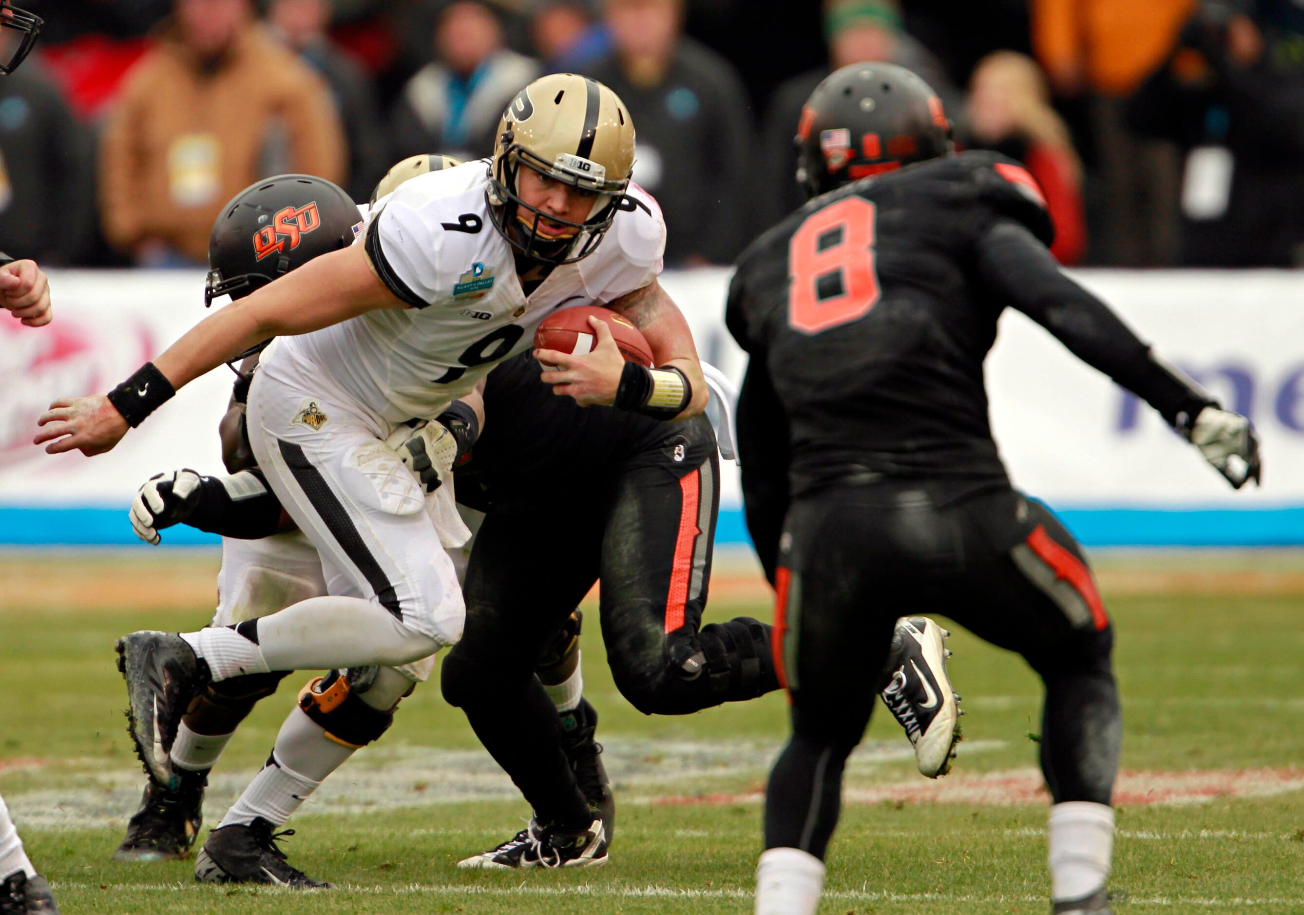 Purdue Boilermakers quarterback Robert Marve (9) tries to scramble out of the pocket during...