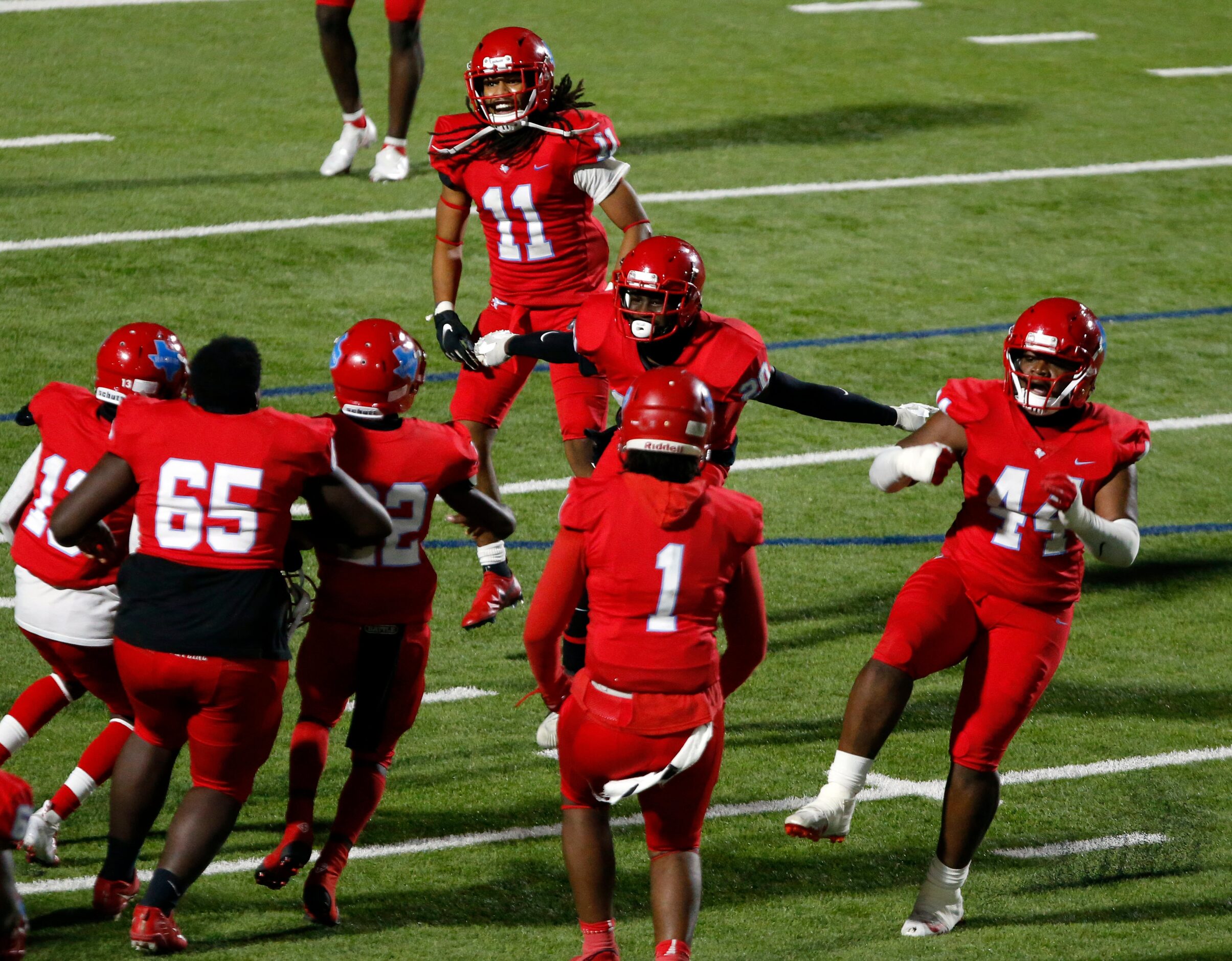 Skyline's  Gregory Johnson (20) celebrates his game-ending interception with teammates...