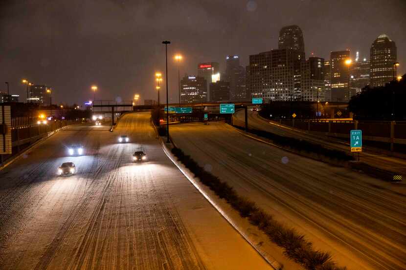 Vehicles drive on North Central Expressway as sleet falls on Thursday, Feb. 3, 2022, in...