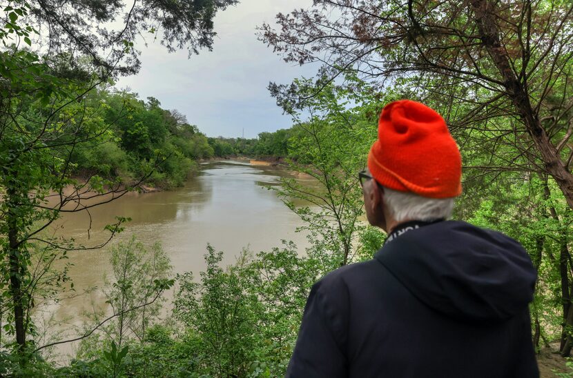 Father Tim Gollob looked out over the Trinity River during a bird-watching expedition at...