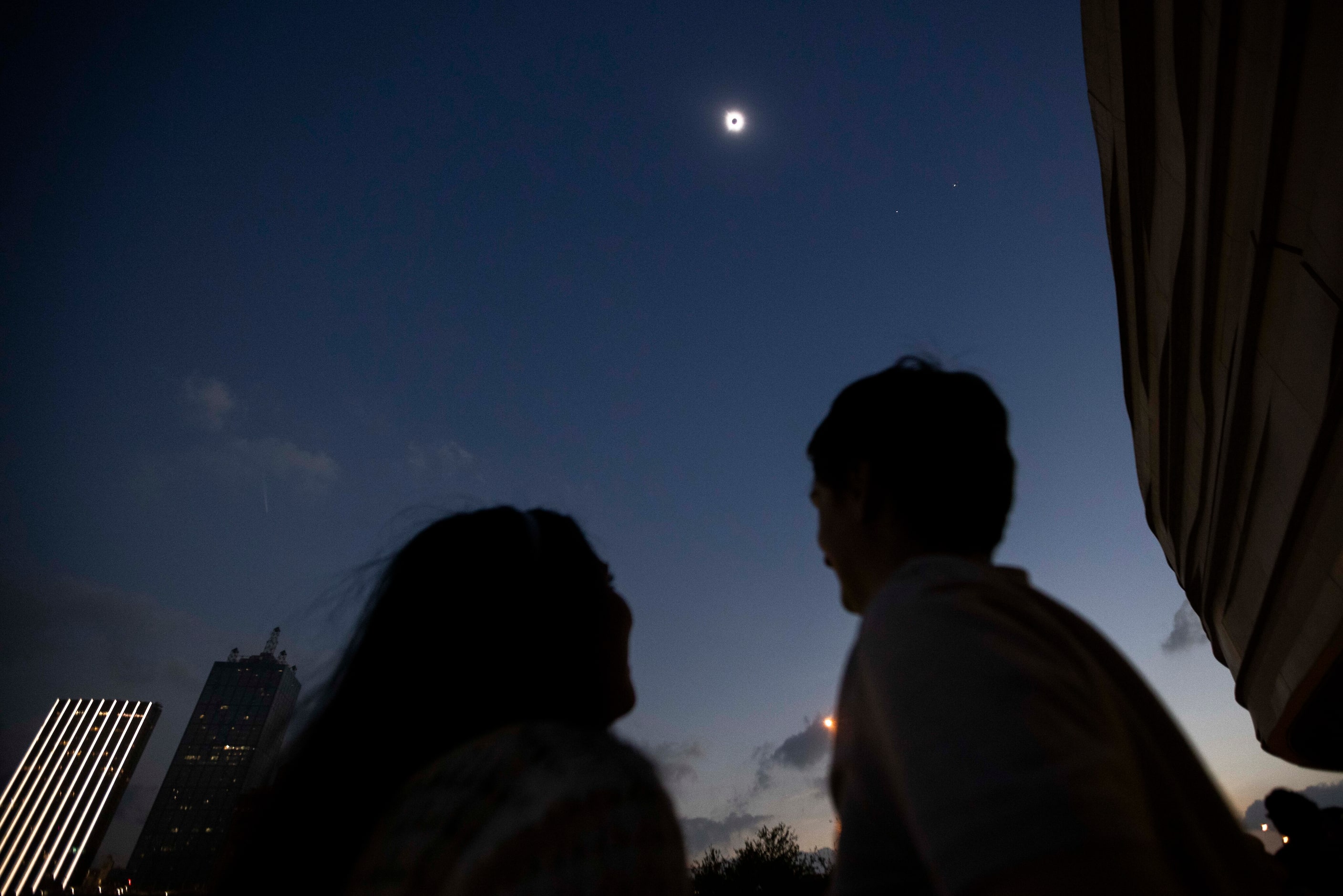 People watch as the eclipse finishes totality during the Great North American Eclipse event...