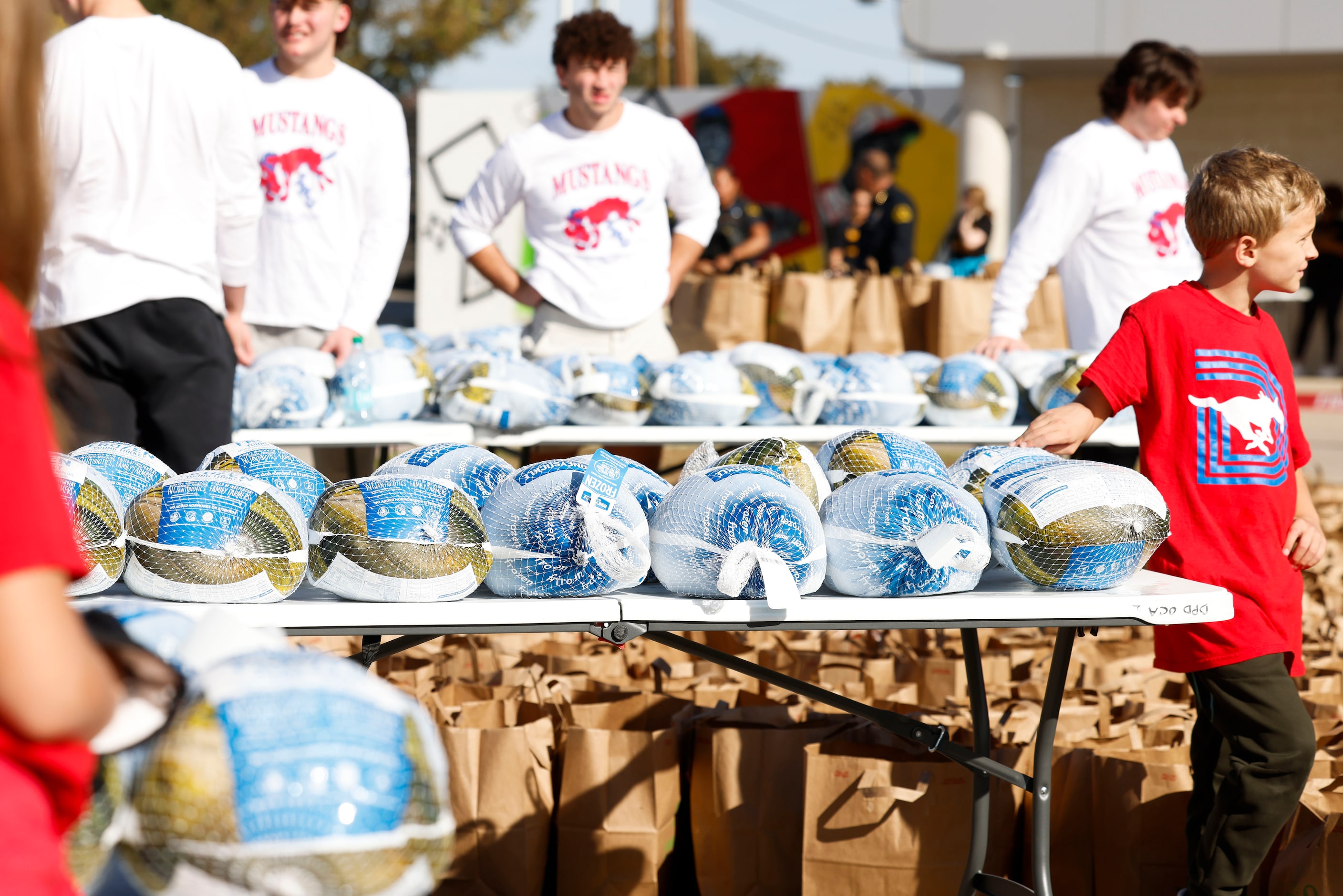 Packs of turkeys remain on the table during a free hand out by Southern Methodist University...