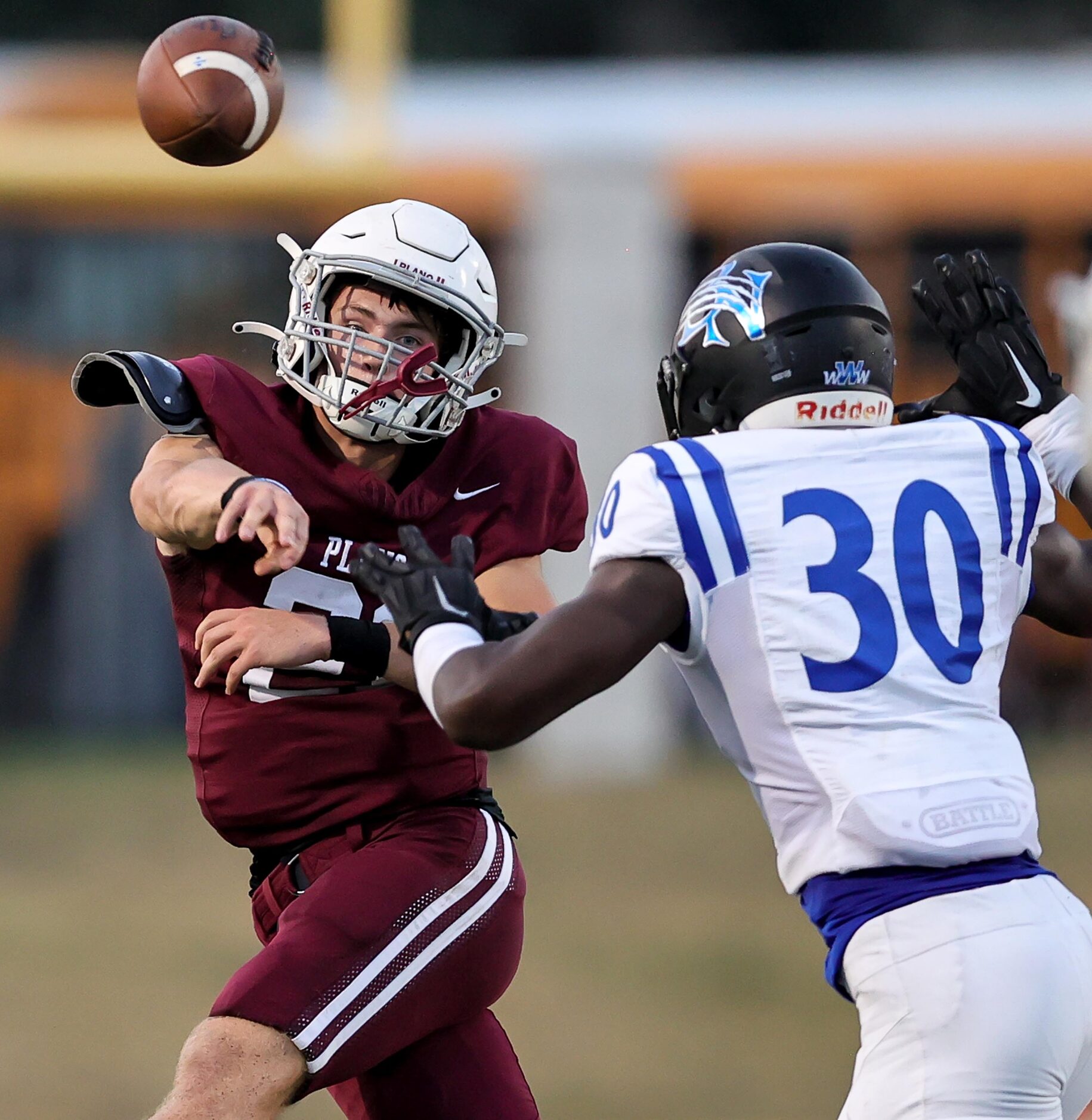 Plano quarterback Jack Thomason, (left) tries to get off a pass as he is pressured by Byron...