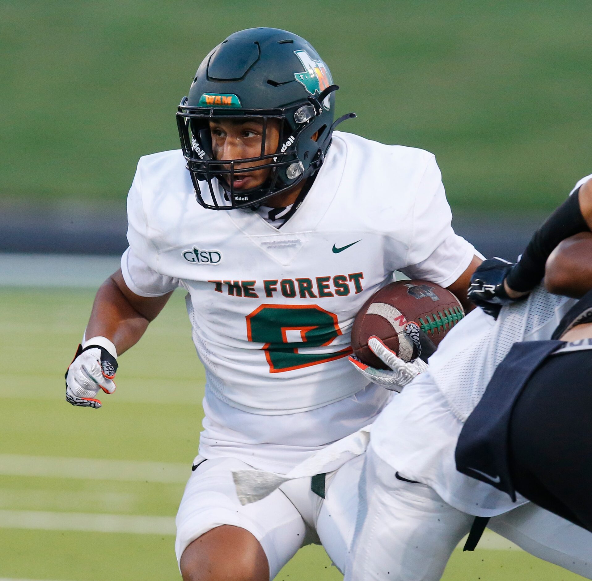 Naaman Forrest High School running back Ivan Garcia (2) cuts behind a block during the first...