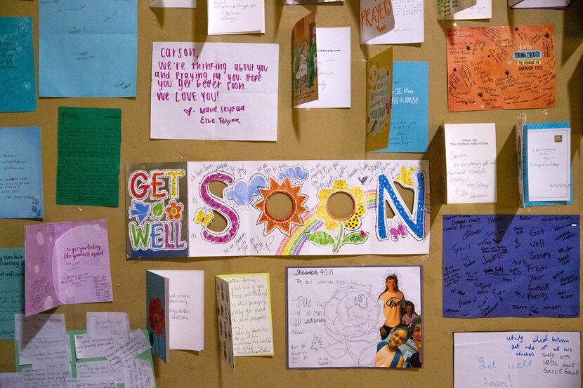 Well-wishing cards adorn the bedroom walls of Flower Mound High School receiver Carson...