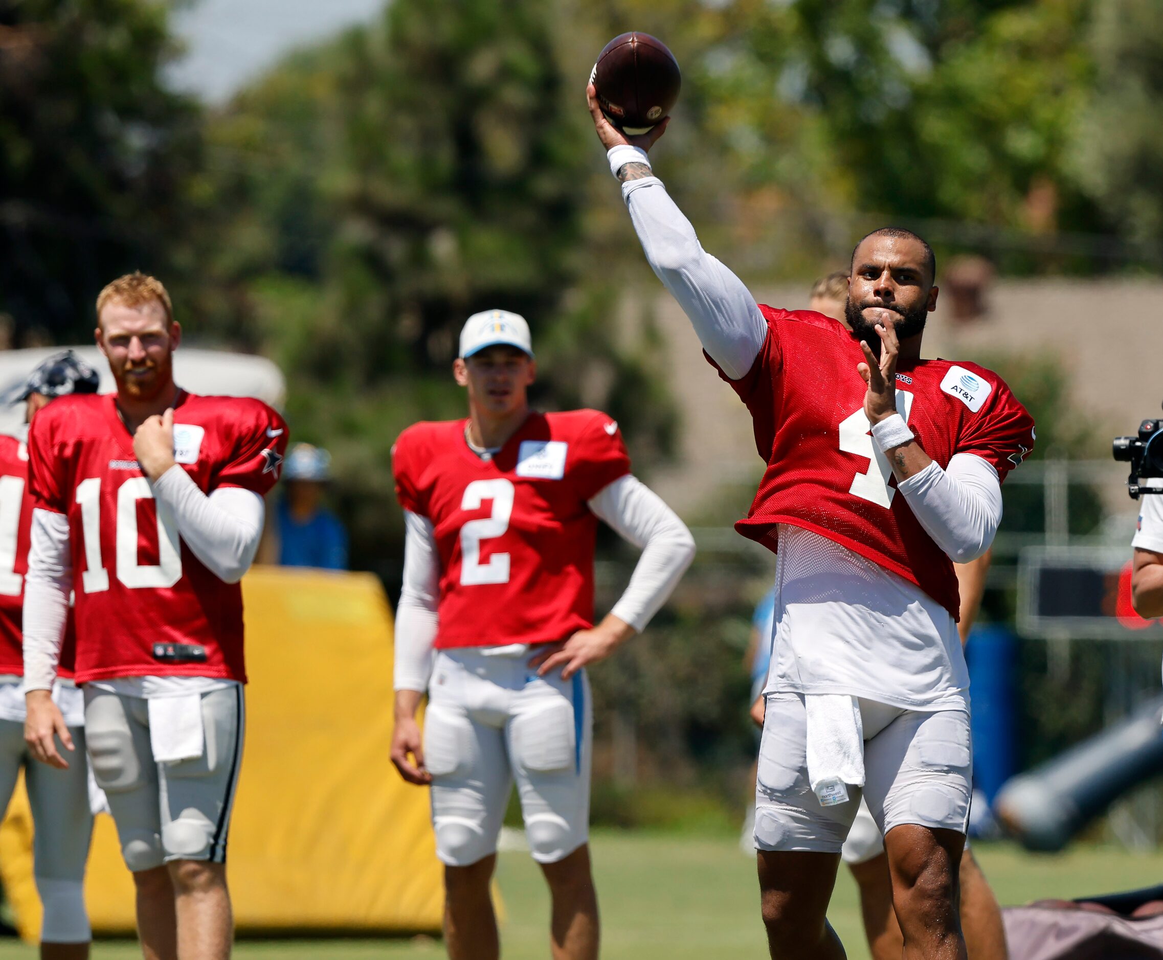 Dallas Cowboys quarterback Dak Prescott (4) throws a pass to a hoop in the end zone...