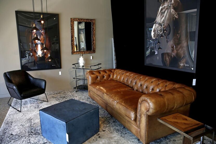 A leather couch  (above) anchors a living-room display at Erdos at Home, a home furnishings...