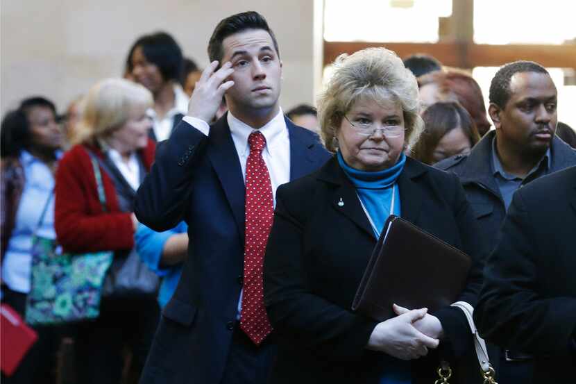 In this Wednesday, Jan. 22, 2014, photo, job seekers line up to meet prospective employers...