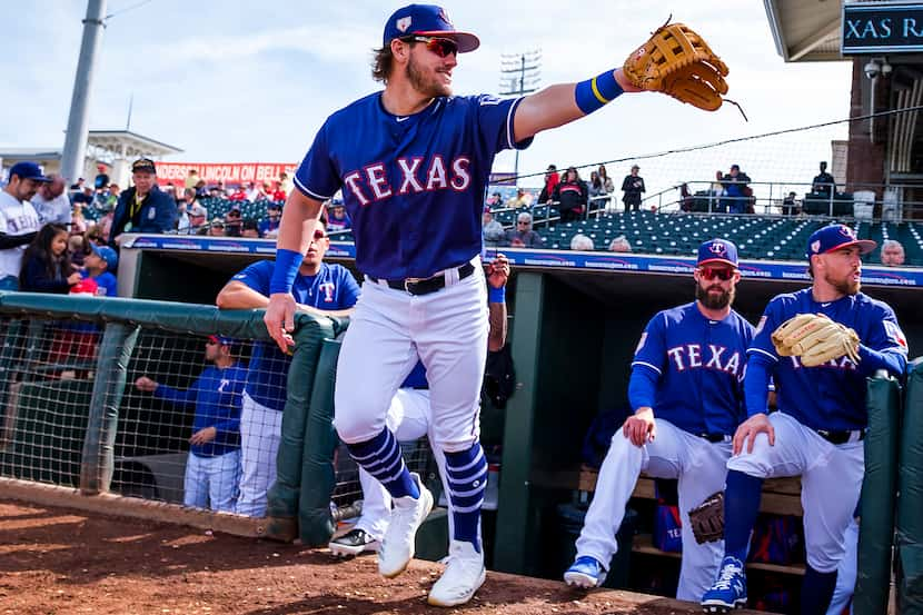 Texas Rangers infielder Patrick Wisdom takes the field before a spring training baseball...