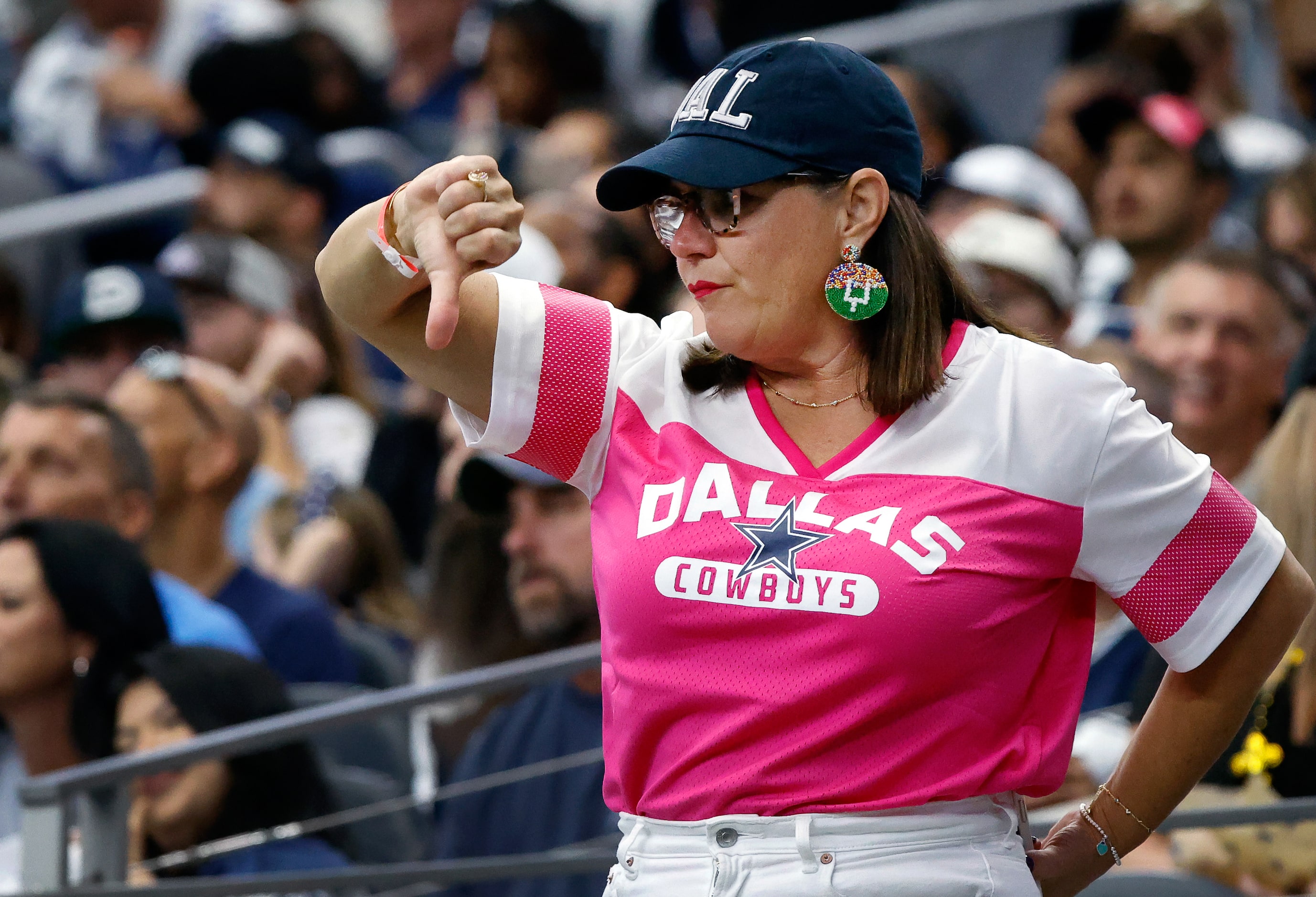 A Dallas Cowboys fan gives a thumbs down as the team struggled against the New Orleans...